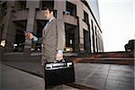 Businessman with Cell Phone and Briefcase