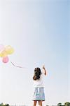 Girl releasing Bunch of Balloons