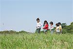 Children Playing In Grassy Field