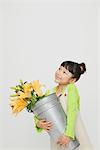 Girl Holding A Bucket With Flowers