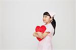 Girl Dressed As Nurse Holding Heart