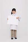 Girl Dressed Up As Doctor Holding Placard