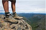 Australia, Tasmania, Cradle Mountain-Lake St Clair National Park.   Hiker standing on the summit of Cradle Mountain.