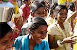 India, Tamil Nadu. Women carrying offerings to the Tamil God of War, Murugan, accompany a Kavadi procession through the streets of Madurai.