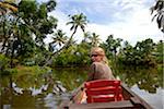 India, Alleppey. A tourist takes a quiet row down the Keralan backwaters.