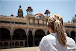 India, Mysore. A tourist looks at the front of Mysore Palace.