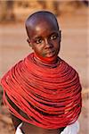 Kenya, Samburu District.  Young Samburu girl in traditional beaded necklaces.