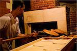 Tripoli, Libye ; Un boulanger sortir le pain du four dans l'un des boulangeries dans l'ancienne médina