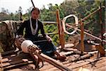 Myanmar, Burma, Keng Tung (Kyaing Tong). An Ann (Enn) lady spinning thread on the platform of her home, Paunglea village, Keng Tung.