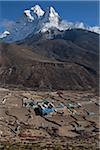 Nepal, Everest Region, Khumbu Valley.  Looking over a remote Sherpa settlement towards to majestic peak of Ama Dablam