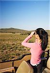 Woman looking through binoculars, Addo Elephant Park, Eastern Cape, South Africa