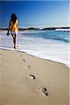 Woman walking on Camps Bay beach, Cape Town, Western Cape, South Africa