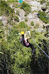 Woman sliding down a zip-line, Storms River, Eastern Cape, South Africa