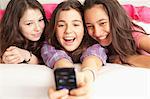 teenage girls taking photos wearing pajamas