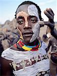 Karo men excel in body art. They decorate their faces and torsos elaborately using local white chalk, pulverised rock and other natural pigments. Their braided hairstyles are typical of young men from the tribe.The Karo are a small tribe living in three main villages along the lower reaches of the Omo River in southwest Ethiopia.