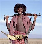 Warriors of the nomadic Afar tribe wear their hair long and carry large curved daggers, known as jile, strapped to their waists.Proud and fiercely independent, they live in the low lying deserts of Eastern Ethiopia.Modern rifles have now replaced daggers as weapons although most young men still wear ornate daggers by tradition.