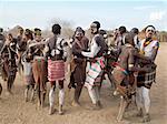 Karo men and girls enjoy a dance.The Karo excel in body art. Before dances and ceremonial occasions, they decorate themselves elaborately using local white chalk, pulverised rock and other natural pigments.The Karo are a small tribe living in three main villages along the lower reaches of the Omo River in southwest Ethiopia.