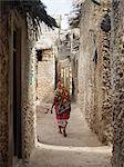 A typical street scene in one of the poorer areas of Pate Village.All the buildings in Pate are constructed of coral rag with makuti roofs, which are a type of thatch made from coconut palm fronds.Pate was established by Arabs from Arabia in the 13th century, or possibly earlier.