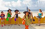 children at beach in witch hats