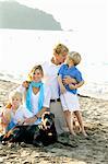 portrait of family on beach with dogs