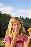 girl eating s'more outdoors