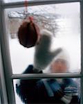 A woman knocking on a window, Sweden.