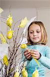 A girl making easter decorations.