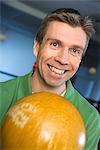 A man with a bowling ball.