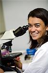 Smiling woman with a microscope, Brazil.