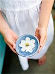 A girl holding a flower in a bowl, Sweden.
