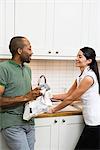 A man and a woman doing the dishes together.