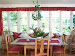 Table and chairs on a glazed-in veranda.