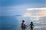 Girls bathing in the sea, Sweden.