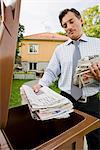 A man recycling newspapers, Sweden.