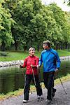 A couple power walking in a park, Sweden.