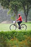 Female cyclist in a park, Stockholm, Sweden.