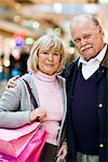 Senior couple carrying shopping bags, Stockholm, Sweden.