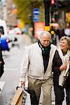 A senior couple carrying shopping bags, Stockholm, Sweden.