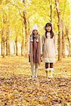 Girls Standing In Park In Autumn