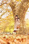 Preteen Girl Leaning Against A Tree