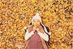 Preteen Girl Lying In Leaves