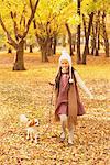 Girl Walking With Dog In Park