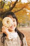 Preteen Girl Looking Trough Hole In Bagel