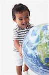 Toddler Boy Playing With Globe Ball