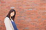 Japanese Teenage Girl Near Bricked Wall