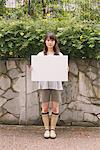 Young adult Woman holding White board