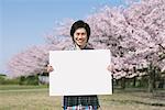 Young Man Holding White Board