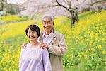 Middle-Aged Japanese Couple In Flowerbed