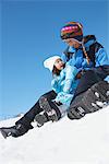 Father Sliding Down With His Daughter In Snow