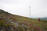 Frau views Säule Berg Windprojektes Windkraftanlagen auf Säule Berg an einem bedeckten Tag, Südwest Alaska, Kodiak Island Sommer